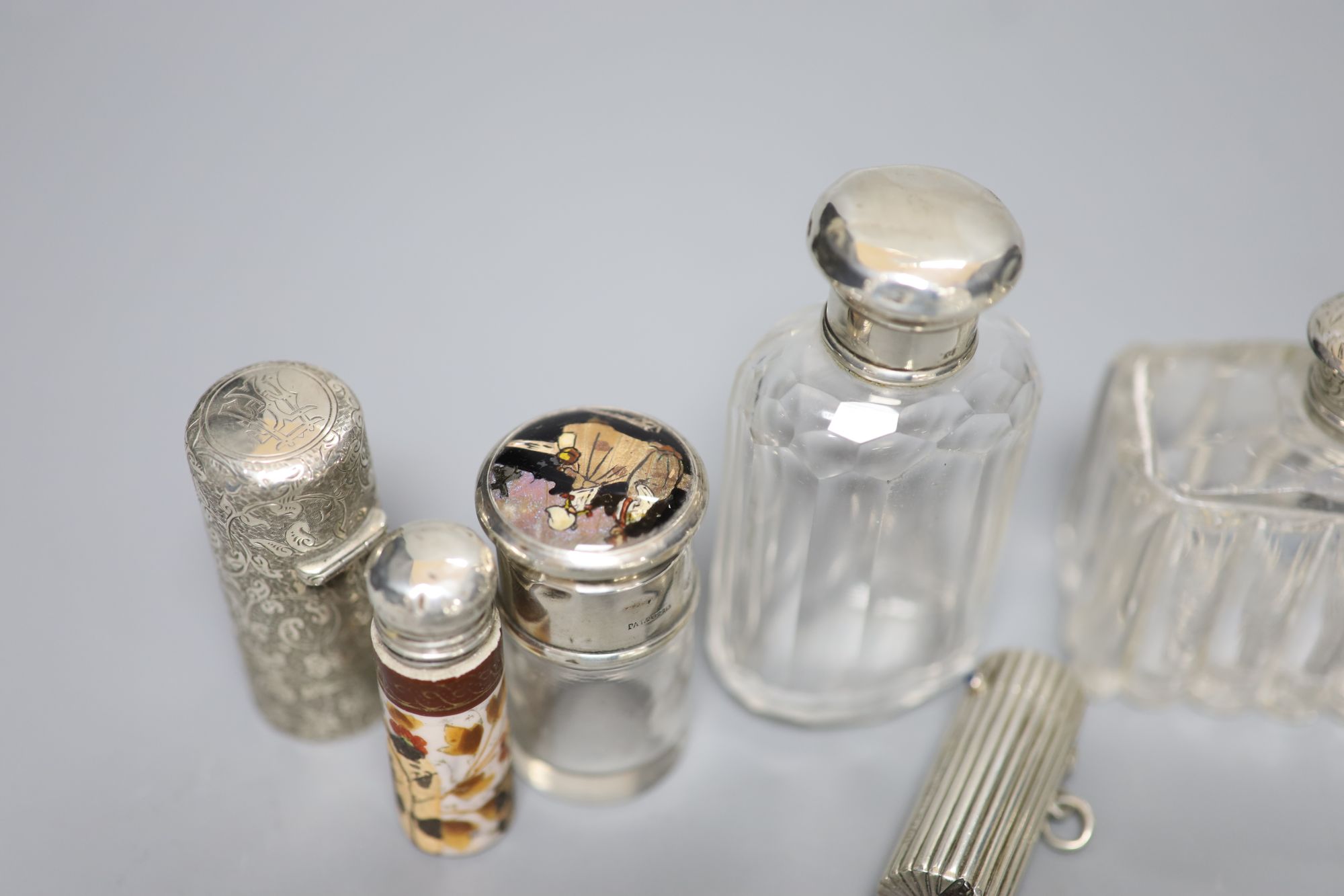 A Victorian cylindrical silver scent bottle by Sampson Mordan & Co, London, 1882, 54mm (a.f.), 8 others and a vest case.